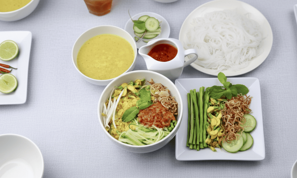 Tangy, rich broth with turmeric and herbs of Bun Num Bo Choc